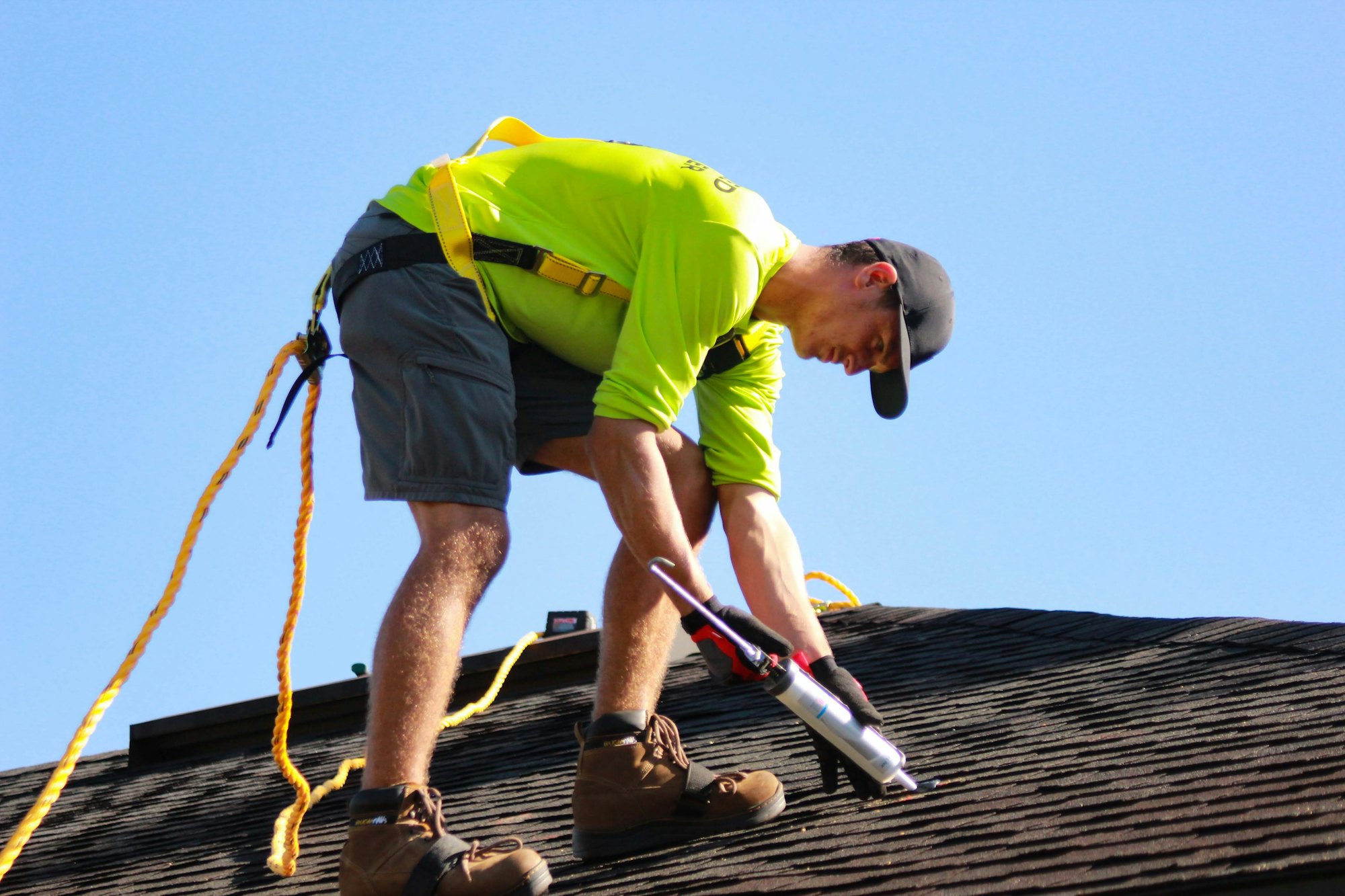 Roofer working on a residential shingle roof