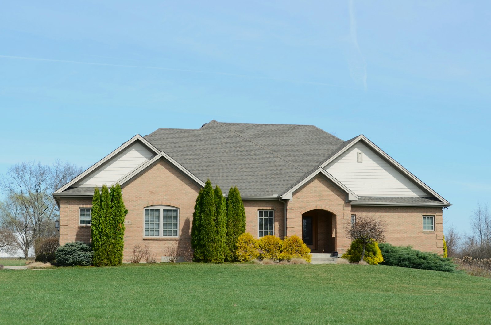 Well-kept suburban brick house with a large lawn